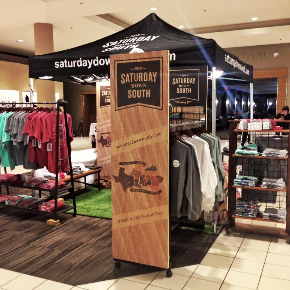 Saturday Down South merchandise booth with shirts and banners
