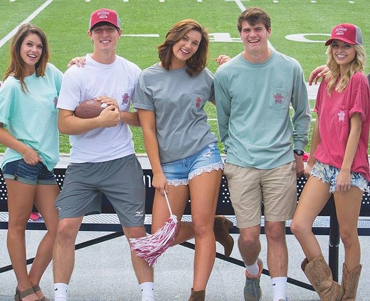 A group wearing Saturday Down South apparel at a football field