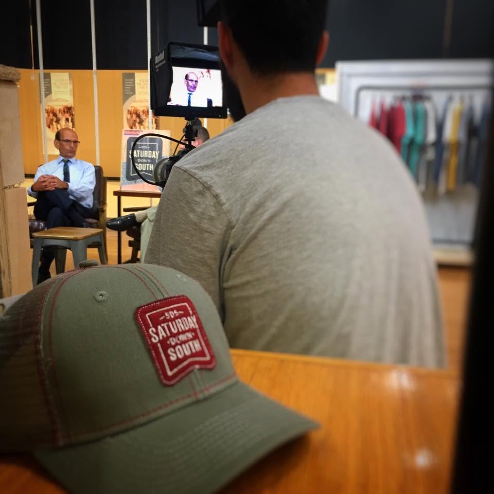 A Saturday Down South hat on a table during a filmed interview