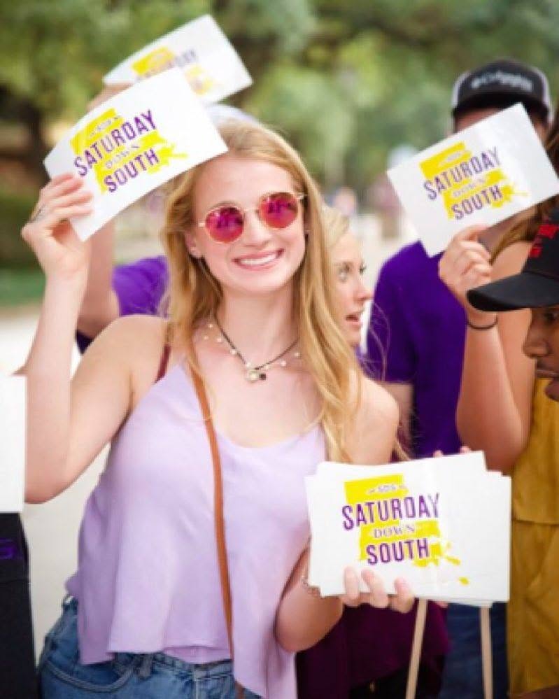 Fans holding Saturday Down South signs